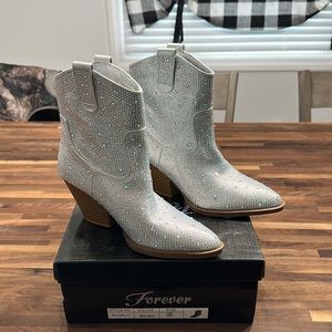 Silver rhinestone encrusted cowboy ankle booties.